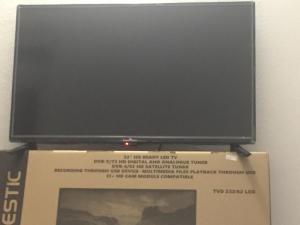 a flat screen tv sitting on top of a box at Airport-FREE shuttle till Night-BIG POOL-air cond-wi fi- sheets&linen wash machine ALL INCLUDED IN PRICE in Olbia