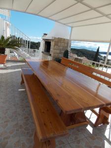 a wooden bench sitting on top of a building at Apartments and Rooms Jasna in Hvar