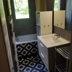 a bathroom with a sink and a mirror at Appartement Saint Gervais les Bains vue imprenable Mont Blanc in Saint-Gervais-les-Bains