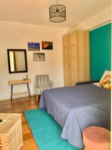 a bedroom with a bed and a table and a mirror at Da Nonno Antonio in Santa Teresa di Riva