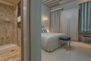 a bedroom with a bed and a bathroom with a tub at Relais Venezia in Venice