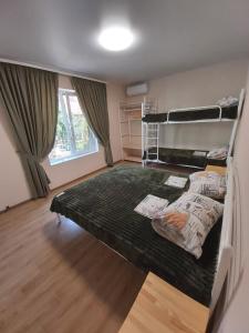 a bedroom with two bunk beds in it at Гостевой дом Вилла Босфор in Sanzhiyka