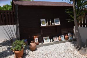 a pretend play house with vases and pictures on a shelf at Unique Beach Luxurious Villas in Ayia Napa