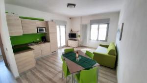a living room with a green couch and a table at Casa Gemma in Malcesine