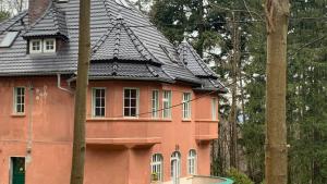 a large orange house with a black roof at Baltic Home in Polanica-Zdrój +22 photos
