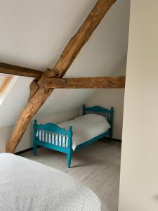 a bedroom with two beds in a attic at Gîte La Roche in Reffuveille