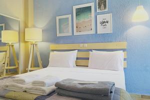 a bedroom with a bed with towels on it at Panormos Beach Hotel Skopelos in Panormos Skopelos