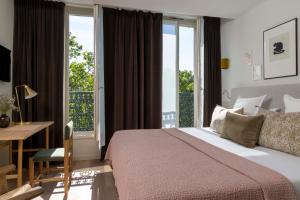 
Säng eller sängar i ett rum på Le Petit Beaumarchais Hotel & Spa Ex Hotel Original
