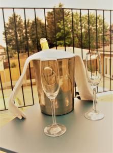 two wine glasses and a ice bucket on a table at The Alvaros Apartment in Southend-on-Sea