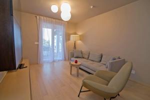 a living room with a couch and a chair at Jelena B4 in Veli Lošinj