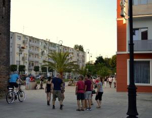 a group of people walking on a city street at Hotel Piast in Nysa