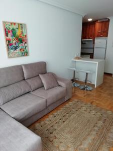 a living room with a couch and a table at Apartamento Conlledo in Villaviciosa
