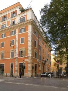 
a building with a clock on the front of it at Hotel Locanda Cairoli in Rome
