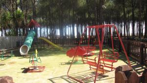 a playground with different types of playground equipment at Happy Camp mobile homes in Camping Thurium Villaggio in Marina di Sibari