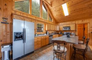 a kitchen with a white refrigerator and wooden walls at BareFoot Cabin cabin in Sevierville