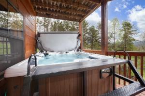 a hot tub on the deck of a cabin at BareFoot Cabin cabin in Sevierville