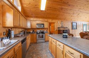 a large kitchen with wooden cabinets and a counter top at BareFoot Cabin cabin in Sevierville