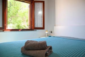 Ένα ή περισσότερα κρεβάτια σε δωμάτιο στο Apartment Azzuro Porto Ottiolu