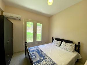 a bedroom with a bed and a window at Chalet with backyard in North Coast near Marina & New Alamein الساحل الشمالي العلمين in El Alamein +55 photos