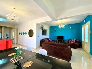 a living room with a couch and a table at Chalet with backyard in North Coast near Marina & New Alamein الساحل الشمالي العلمين in El Alamein