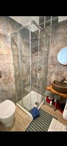 a bathroom with a shower and a toilet and a sink at B&B La Caldosa in Olbia
