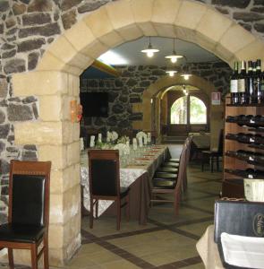 a dining room with a table and a stone wall at Villa Renna ex Casina Cancellieri in Francofonte