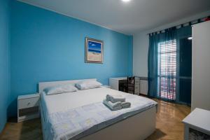 Ein Bett oder Betten in einem Zimmer der Unterkunft Apartments Onorina
