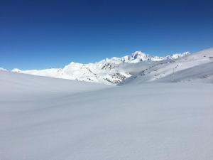 a snow covered mountain range with mountains in the background at Le choucas - Les Arcs in Arc 2000
