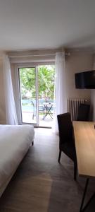 Katil atau katil-katil dalam bilik di Hostellerie du Parc