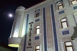 a building with a sign on the side of it at Sultan Hotel Boutique in Samarkand
