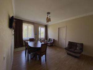 a living room with a dining room table and chairs at Geo Inn in Kazbegi