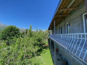 a balcony of a house with a view of the mountains at Geo Inn in Kazbegi