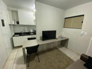 Il comprend une cuisine avec un bureau et une télévision. dans l'établissement Moradas Pará Satélite 303, à Belém