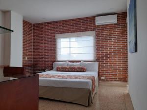 Postel nebo postele na pokoji v ubytování HOTEL OSCAR Tradición