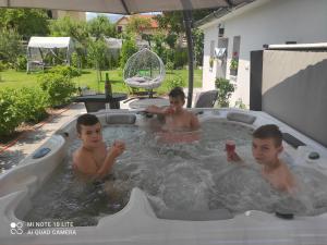 three boys in a jacuzzi bathtub at Apartmán Martin in Martin