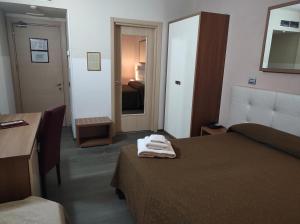 Postel nebo postele na pokoji v ubytování Hotel Antica Tabaccaia Resort