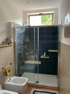 a bathroom with a shower and a toilet and a sink at Casa Cristina in Alì Terme