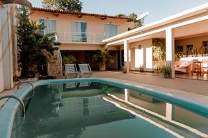 a swimming pool in front of a house at Pousada Alpes in Triunfo