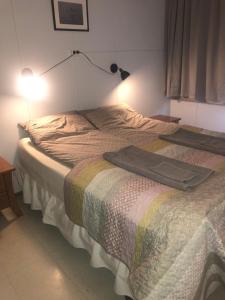 a bedroom with a bed with a blanket on it at Guesthouse Langafit in Laugarbakki