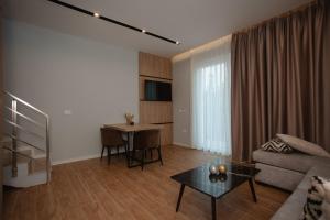 a living room with a couch and a table at Premium Villas Resort in Shëngjin