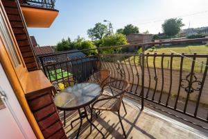 a balcony with a table and chairs and a field at Pokoje Gościnne Martynka in Białogóra