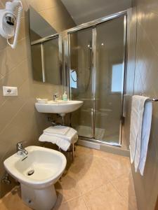 a bathroom with a shower and a sink and a toilet at Villa Santacroce in San Giovanni Rotondo