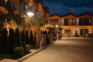 a house with lights on the side of a driveway at Premium Villas Resort in Shëngjin