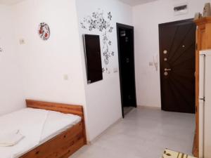 a bedroom with a bed and a black door at Ruse Central Studio in Ruse