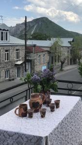 a table with flowers on it on a balcony at L&A Guest House in Goris
