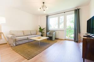 a living room with a couch and a table at Cisna Apartament in Cisna