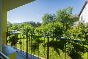 a balcony with a view of a yard at Cisna Apartament in Cisna