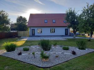 a house with a garden in front of it at Apartament na Cysterskim Szlaku in Starzyno