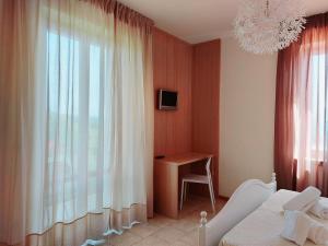 A bed or beds in a room at Hotel Valbella