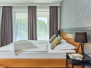 a bedroom with a large bed with a window at B&B Plitvice Lacus in Seliste Dreznicko
